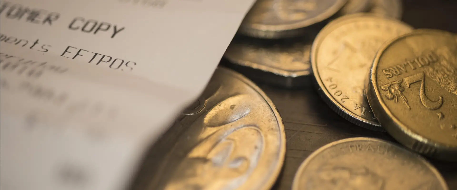 Monedas de euro y texto &ldquo;FTTprocs&rdquo;; primer plano sobre billete desenfocado