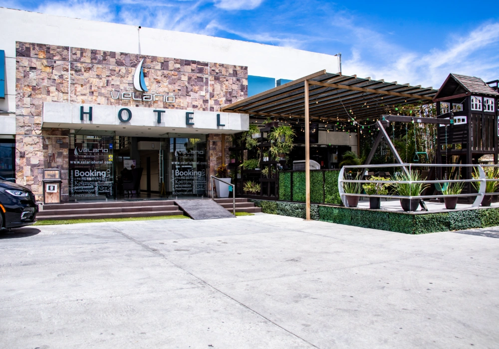Entrada de hotel Velerio, con patio y letrero &ldquo;HOTEL&rdquo; al frente