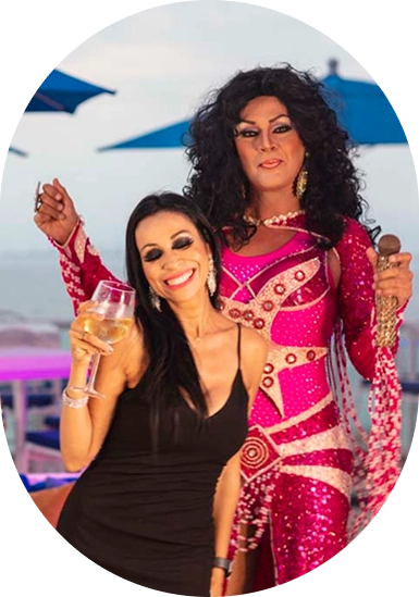 Two women in festive pink costumes posing and smiling at an event.