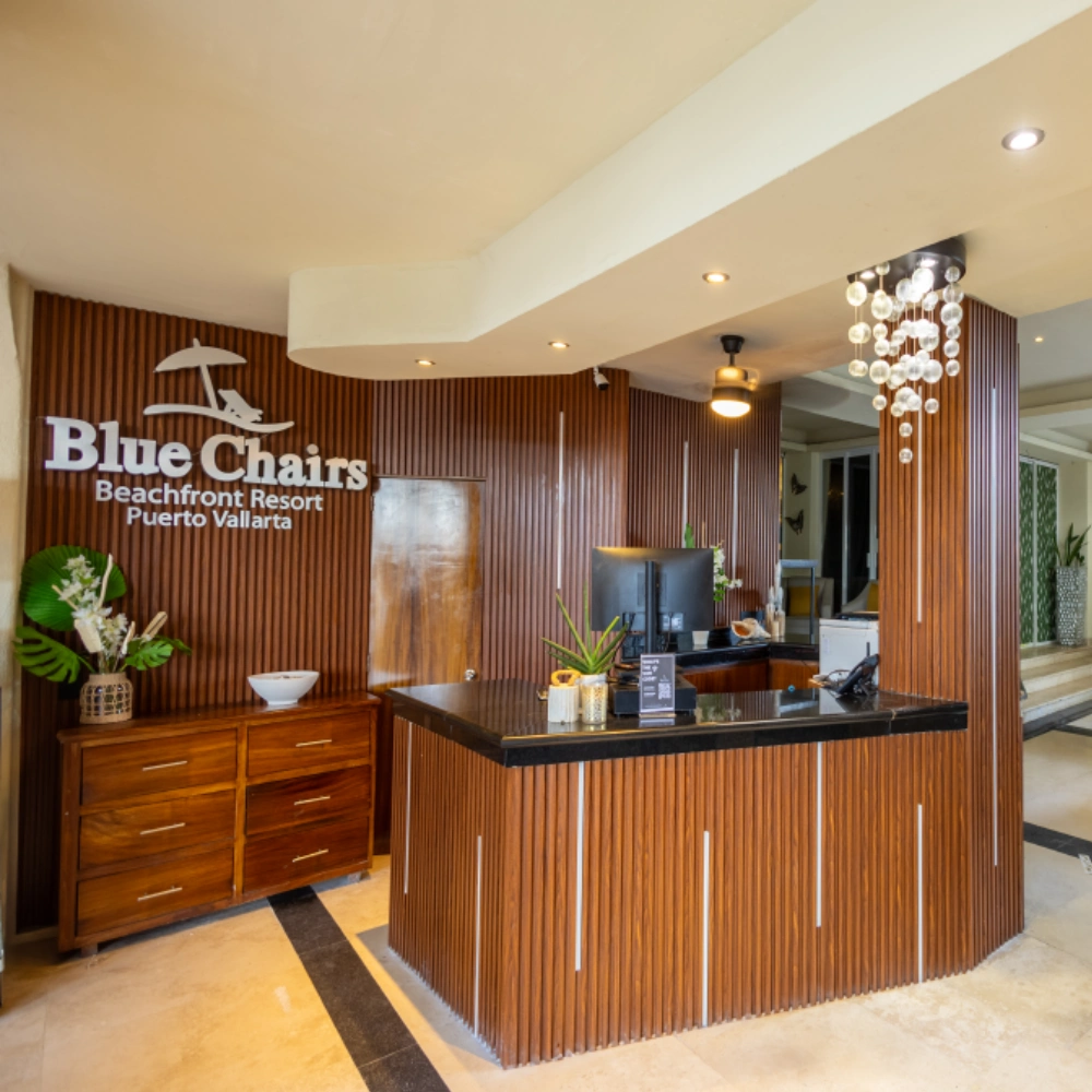 Hotel reception desk with wood paneling and chandelier in Blue Chairs lobby