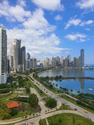 Vista panor&aacute;mica de una ciudad costera con rascacielos y bah&iacute;a.