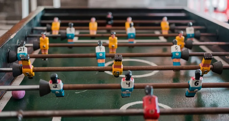 View of a foosball table with plastic players and number scoreboard
