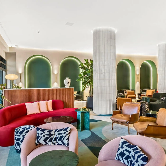 Modern living room with colorful armchairs and tall white and green columns