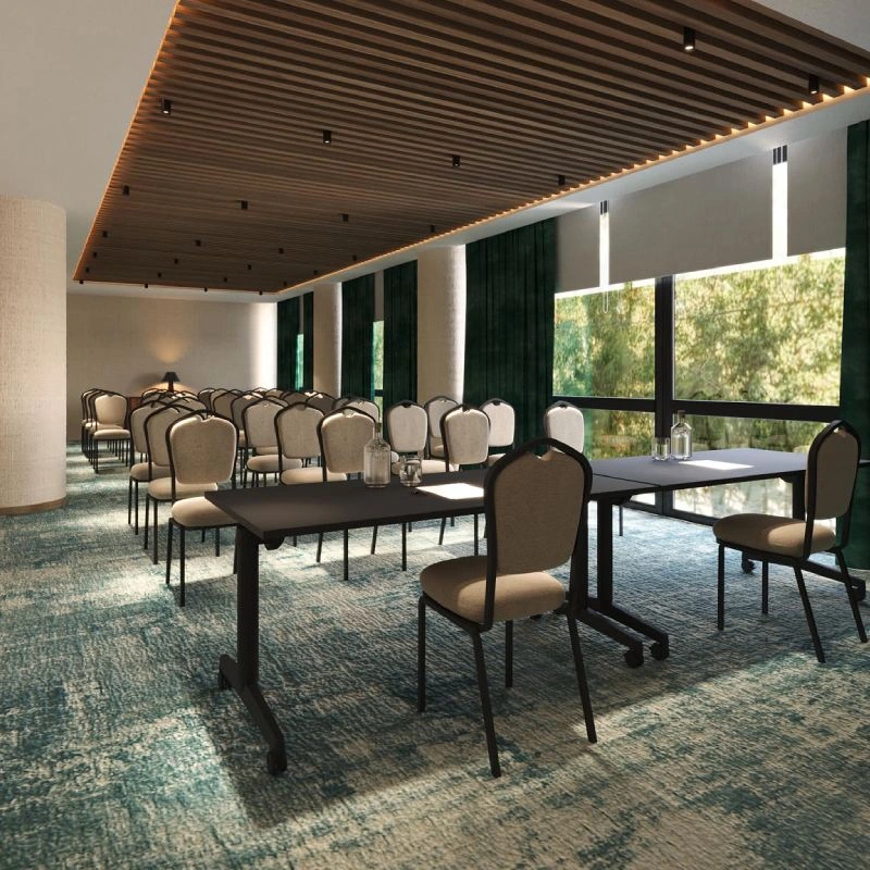 Modern meeting room with tables and chairs, large window, and built-in lighting