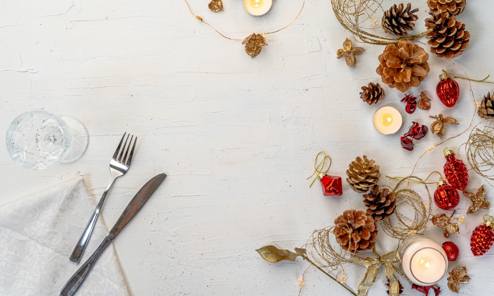 overhead-shot-of-rustic-colorful-christmas-dining-table-with-decors-and-space-for-text (1)