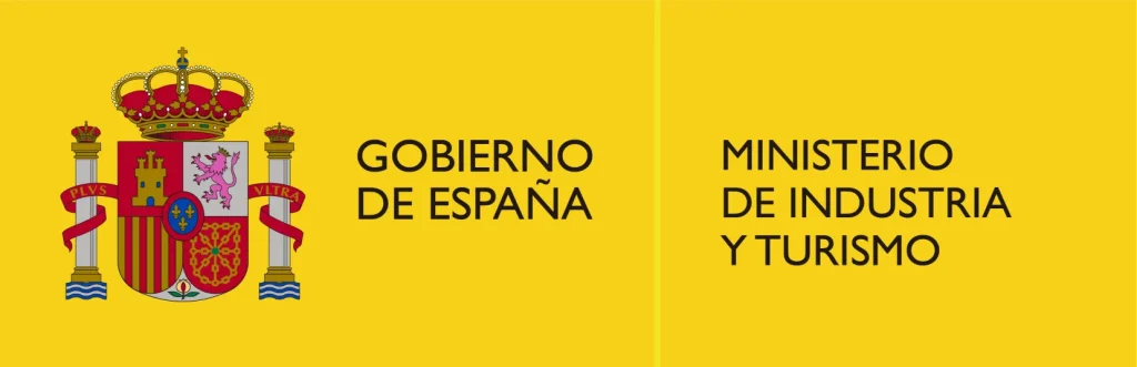 Escudo de España, Gobierno y Ministerio de Industria y Turismo. Fondo amarillo.