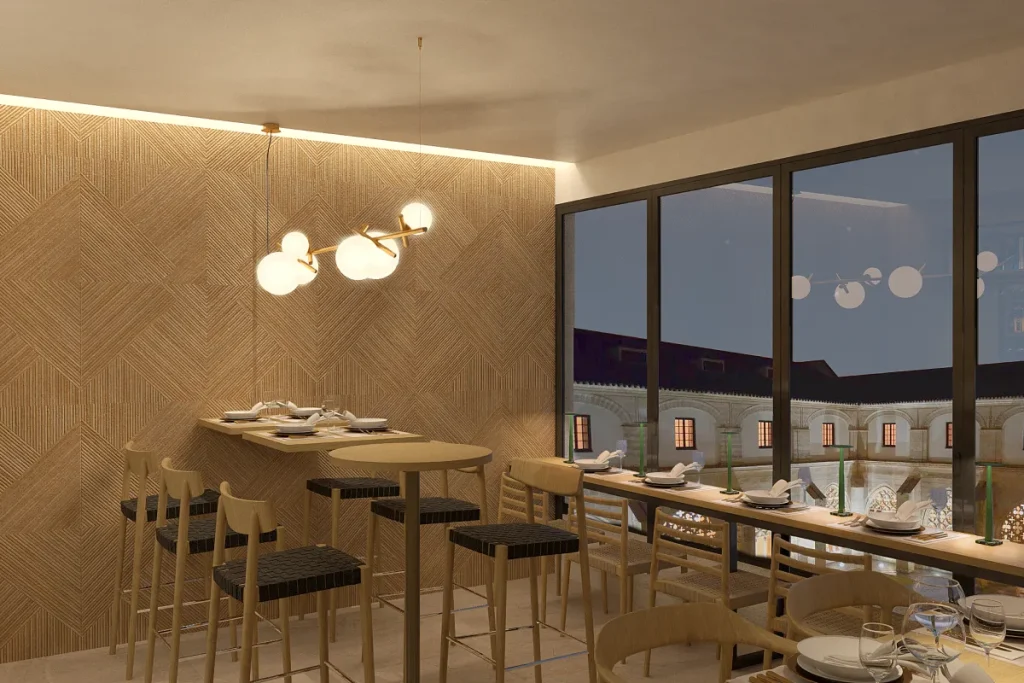 Comedor con mesa, sillas y l&aacute;mpara colgante, junto a grandes ventanales.