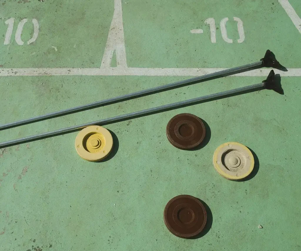 Dos mangueras con tapas amarillas y marrones sobre una superficie verde con n&uacute;meros &ldquo;10&rdquo; y &ldquo;11&rdquo;.